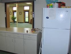 in kitchen, looking north into community room